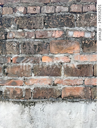 Weathered brick wall texture with rough mortar and signs of age Weathered brick wall texture with rough mortar and signs of age 140916201