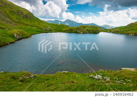 lake in romania mountain landscape. clear source of water. outdoor adventures in summer. cloudy sky over the fagaras ridge lake in romania mountain landscape. clear source of water. outdoor adventures in summer. cloudy sky over the fagaras ridge 140916462