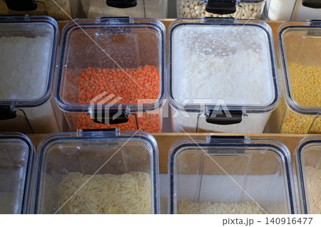 Dry food storage system for kitchen pantry drawers. Square plastic containers, top view. Dry food storage system for kitchen pantry drawers. Square plastic containers, top view. 140916477