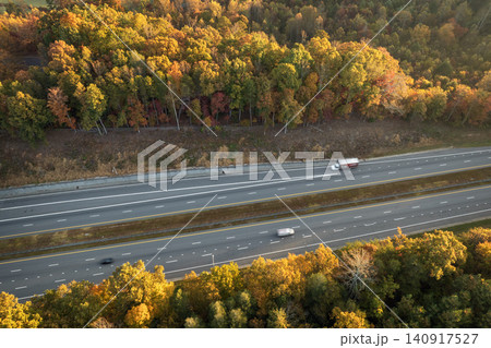 Freeway road with fast moving traffic cars and trucks in North Carolina Appalachian mountains in fall season. Interstate transportation infrastructure in USA Freeway road with fast moving traffic cars and trucks in North Carolina Appalachian mountains in fall season. Interstate transportation infrastructure in USA 140917527