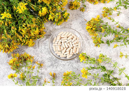 Hypericum powder in capsules with a bouquet of flowers, a medicinal herbal composition, an alternative folk medicine concept, an advertisement for a green pharmacy, a collection of useful herbs Hypericum powder in capsules with a bouquet of flowers, a medicinal herbal composition, an alternative folk medicine concept, an advertisement for a green pharmacy, a collection of useful herbs 140918028