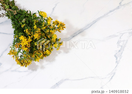 Hypericum flowers on a concrete table, herbal remedies, alternative folk medicine concept, green pharmacy advertisement, collection of useful herbs for folk medicine, source of vitamins 140918032