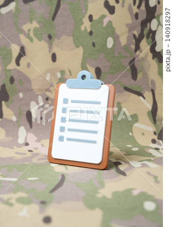 Paper tablet on a military background. Tests and reports. Fitness criteria for service. Audit and revision. Paper tablet on a military background. Tests and reports. Fitness criteria for service. Audit and revision. 140918297