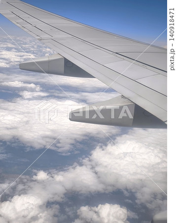 Passenger aircraft wing above thick white clouds Passenger aircraft wing above thick white clouds 140918471