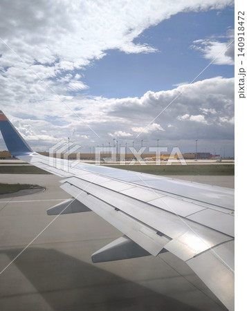 View of an airplane wing at the airport before departure. View of an airplane wing at the airport before departure. 140918472