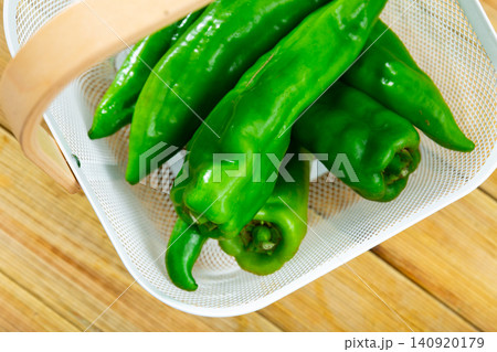 Green peppers on wooden table, cooking ingredients Green peppers on wooden table, cooking ingredients 140920179