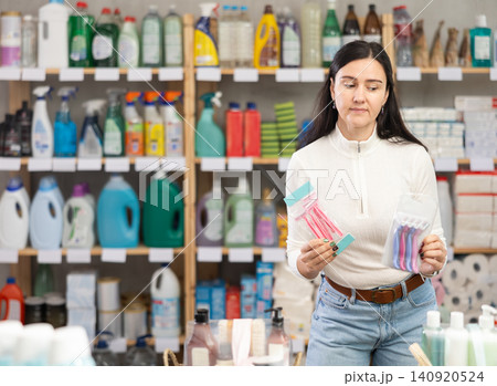Woman choosing hair shaving machines in supermarket Woman choosing hair shaving machines in supermarket 140920524