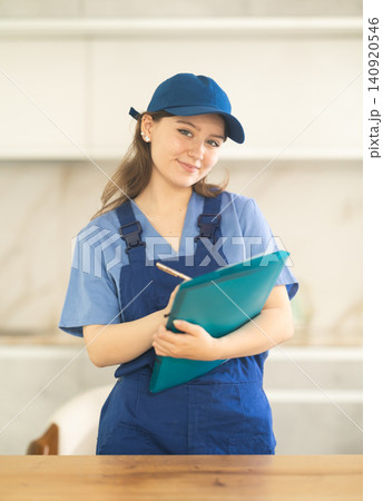 Young female worker making notes in documents Young female worker making notes in documents 140920546