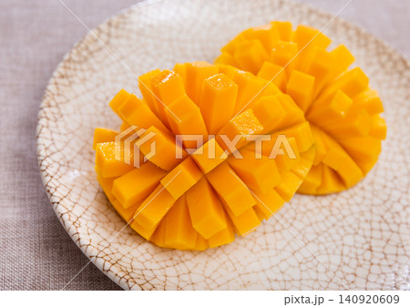 Set with sweet ripe mangoes cut into cubes on plate. Top view Set with sweet ripe mangoes cut into cubes on plate. Top view 140920609