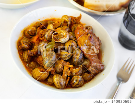Stewed snails with rabbit meat and sausages 140920693