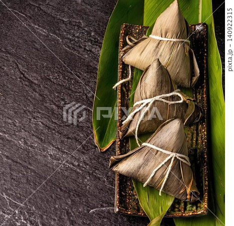 Close-up of banana leaves with brown dried leaves on dark wood 140922315