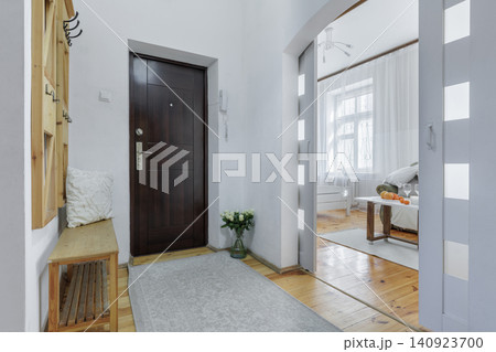 Apartment Entrance Hallway with Dark Door and Living Room View Apartment Entrance Hallway with Dark Door and Living Room View 140923700