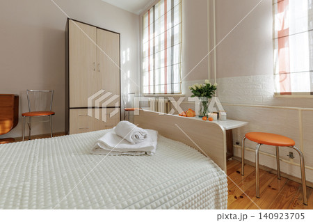 Cozy Bedroom Interior with Wooden Wardrobe and Orange Chairs Cozy Bedroom Interior with Wooden Wardrobe and Orange Chairs 140923705