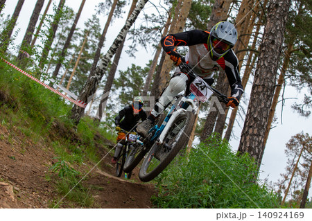 Two athletes racer riding downhill 140924169
