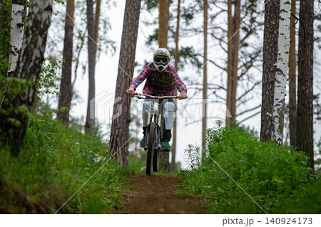 Man athlete racer riding downhill Man athlete racer riding downhill 140924173