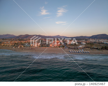 Drone View of Coastal Resort Town with Mountains under Sunset Sky Drone View of Coastal Resort Town with Mountains under Sunset Sky 140925467