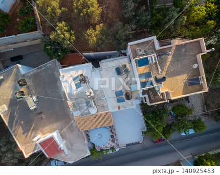 Top Down Drone View of House Rooftops with Solar Panels and Water Heaters Top Down Drone View of House Rooftops with Solar Panels and Water Heaters 140925483