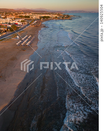 Aerial View of Sandy Beach with Sunbeds and Waves at Sunrise Aerial View of Sandy Beach with Sunbeds and Waves at Sunrise 140925504