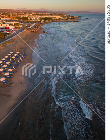 Aerial View of Sandy Beach with Sunbeds and Waves at Sunrise Aerial View of Sandy Beach with Sunbeds and Waves at Sunrise 140925505