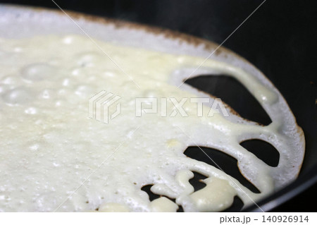 Close-Up of Crepe on Skillet: Texture and Cooking Process Close-Up of Crepe on Skillet: Texture and Cooking Process 140926914