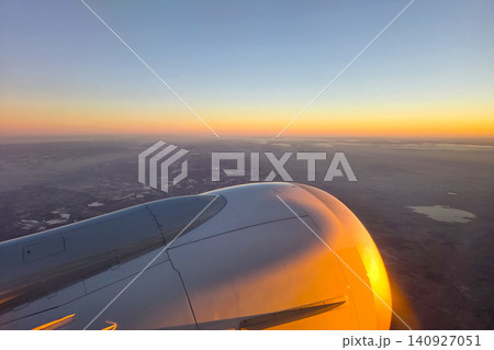 Stunning Aerial View of Colorful Sunset over Landscape from Airplane Window Stunning Aerial View of Colorful Sunset over Landscape from Airplane Window 140927051