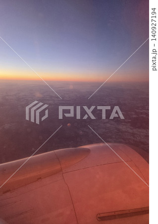 Sunset View from Airplane Window Over Expansive Landscape for Travel Inspiration 140927194