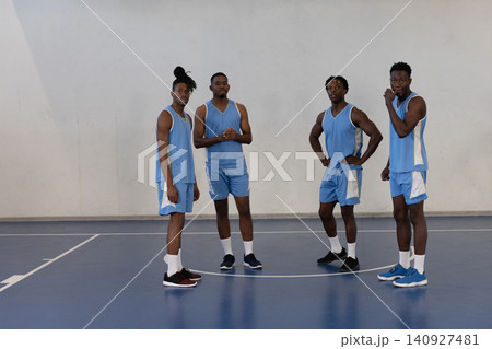 African american male teammates in line on gym court wearing matching jerseys and shoes 140927481
