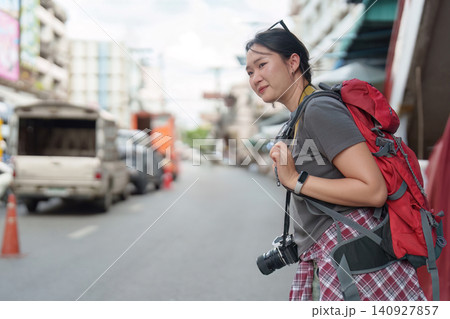 Asian woman backpacker exploring city street during summer travel vacation Asian woman backpacker exploring city street during summer travel vacation 140927857
