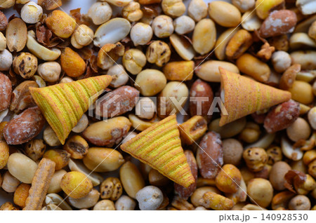 Colorful crunchy treats mixed with an assortment of nuts and seeds create a vibrant snack medley on a sunny afternoon 140928530