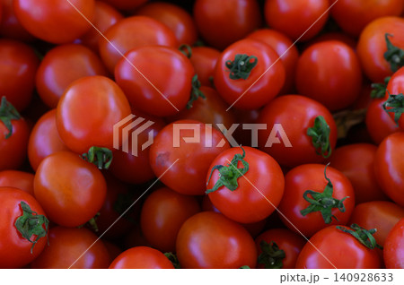 Vibrant cherry tomatoes freshly harvested from a sunny garden, showcasing their rich color and healthy sheen Vibrant cherry tomatoes freshly harvested from a sunny garden, showcasing their rich color and healthy sheen 140928633