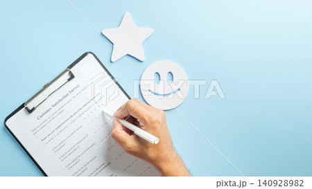 Hand completes customer satisfaction survey form, providing valuable business data feedback, check review for service, smiley face and star icons stand out on blue background 140928982
