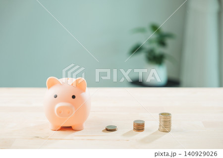 Piggy bank and increasing money stacks illustrate business growth, finance planning for future investment and long term savings, showing smart financial strategy Piggy bank and increasing money stacks illustrate business growth, finance planning for future investment and long term savings, showing smart financial strategy 140929026