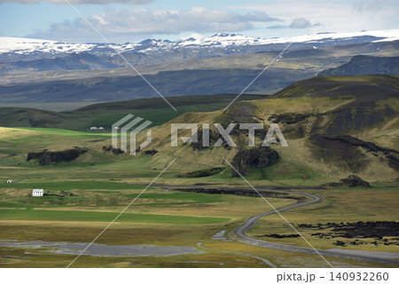 Winding road through a green volcanic valley towards Eyjafjallajokull glacier Iceland Winding road through a green volcanic valley towards Eyjafjallajokull glacier Iceland 140932260