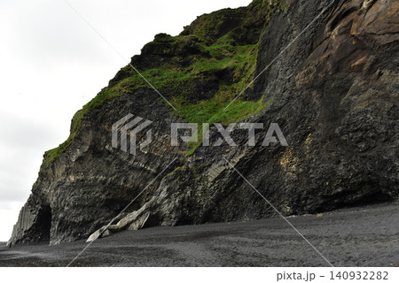 Dramatic volcanic basalt cliffs and black sand beach at Reynisfjara Iceland Dramatic volcanic basalt cliffs and black sand beach at Reynisfjara Iceland 140932282