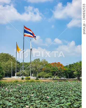 Thai national flag over lotus pond at Wat Yanasangwararam temple grounds in Chonburi Thailand Thai national flag over lotus pond at Wat Yanasangwararam temple grounds in Chonburi Thailand 140932533