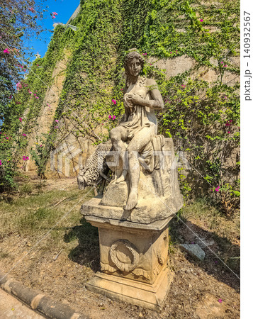 Classical stone sculpture of female figure with sheep in garden at Castello Di Bellagio Pattaya Thailand Classical stone sculpture of female figure with sheep in garden at Castello Di Bellagio Pattaya Thailand 140932567