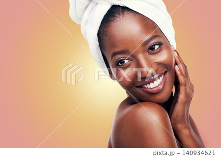 Happy woman and skincare with towel in studio for beauty, dermatology and mockup on gradient or orange background. Facial glow of a young model or African person with smile for hygiene and cosmetics Happy woman and skincare with towel in studio for beauty, dermatology and mockup on gradient or orange background. Facial glow of a young model or African person with smile for hygiene and cosmetics 140934621