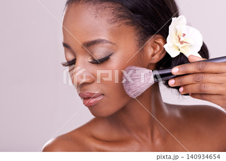 Cosmetic glow, makeup brush on face and black woman with skincare in studio, cosmetics tool. Skin care, blush and foundation, African beauty model with luxury contour highlight on pink background Cosmetic glow, makeup brush on face and black woman with skincare in studio, cosmetics tool. Skin care, blush and foundation, African beauty model with luxury contour highlight on pink background 140934654