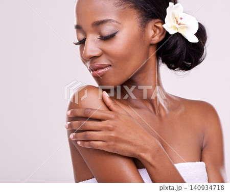 Skincare, cosmetics and black woman with flower in studio with beauty, wellness and face care. Salon aesthetic, dermatology and isolated person for natural skin, spa and facial on white background Skincare, cosmetics and black woman with flower in studio with beauty, wellness and face care. Salon aesthetic, dermatology and isolated person for natural skin, spa and facial on white background 140934718