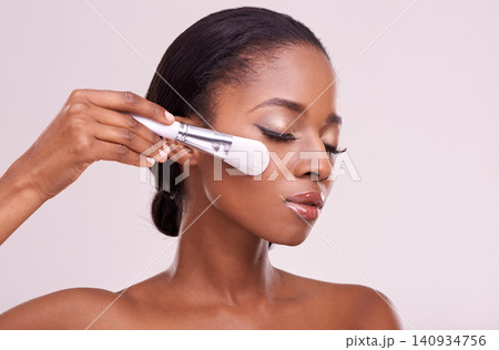 Skincare, makeup and black woman with brush on face in studio mockup with cosmetic application tool. Beauty, blush and cosmetics, facial skin care model with luxury glow product on grey background. Skincare, makeup and black woman with brush on face in studio mockup with cosmetic application tool. Beauty, blush and cosmetics, facial skin care model with luxury glow product on grey background. 140934756