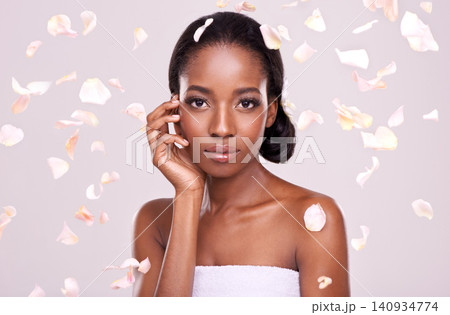 Portrait, skincare and petals with natural black woman in studio on pink background for wellness. Face, beauty and cosmetics with serious young aesthetic model at spa for dermatology treatment 140934774