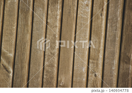 Close up of weathered brown vertical wooden slats texture background Close up of weathered brown vertical wooden slats texture background 140934778