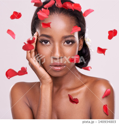 Portrait, beauty and petals with natural black woman in studio on pink background for wellness. Face, skincare and cosmetics with serious young aesthetic model at spa for dermatology treatment Portrait, beauty and petals with natural black woman in studio on pink background for wellness. Face, skincare and cosmetics with serious young aesthetic model at spa for dermatology treatment 140934803