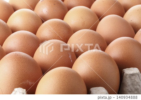 Brown chicken eggs in a carton isolated on a white background Brown chicken eggs in a carton isolated on a white background 140934888