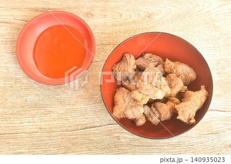 fried salty pork belly with garlic on bowl dipping spicy chili sauce fried salty pork belly with garlic on bowl dipping spicy chili sauce 140935023