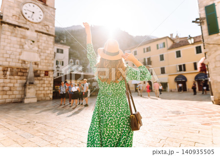 Happy smiling woman wearing trendy summer outfit walking in street of European city. Fashion 140935505