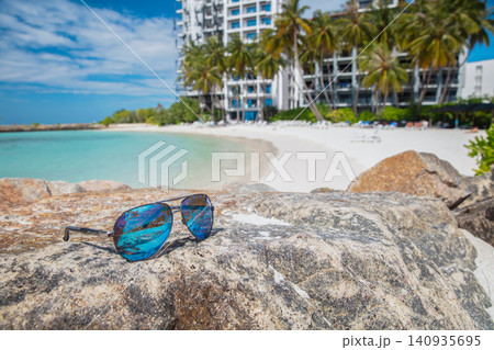 Sunglasses lie on a rock 140935695