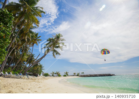 Tropical palm tree on beach with blue sky abstract background 140935710