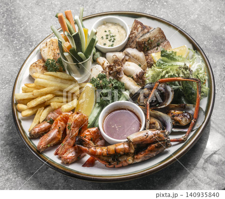 mixed mediterranean fish and seafood assortment plate on spanish restaurant table mixed mediterranean fish and seafood assortment plate on spanish restaurant table 140935840