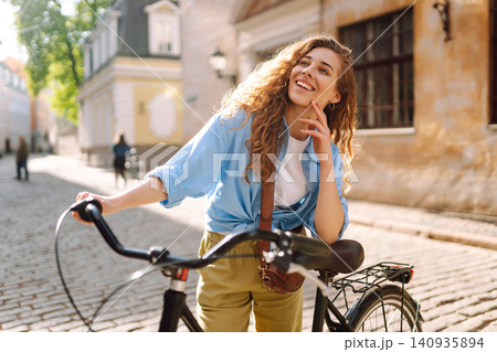 Happy woman tourist using bicycle in city street. Free time after work and study, lifestyle. Happy woman tourist using bicycle in city street. Free time after work and study, lifestyle. 140935894